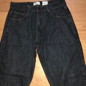 Dark blue jeans pants that are stretchy and the brand “members”
